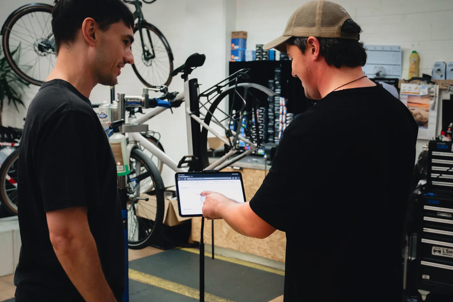 A Zelo Bikes team member talking with a customer on the shop floor